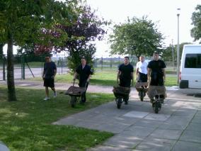 Here comes the Navy! Sailors arriving with wheelbarrows.